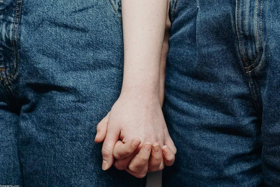 A couple holding hands.