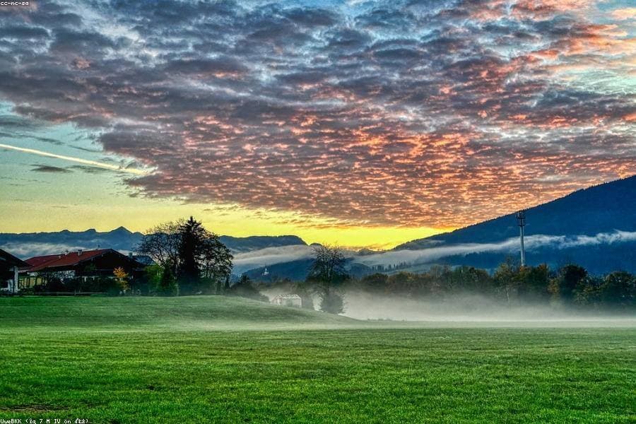 Sunrise breaking over an open field.