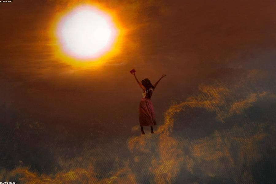 A woman worshipping with her hands raised.