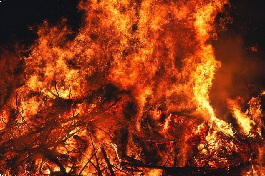 A bonfire blazing against the night sky.