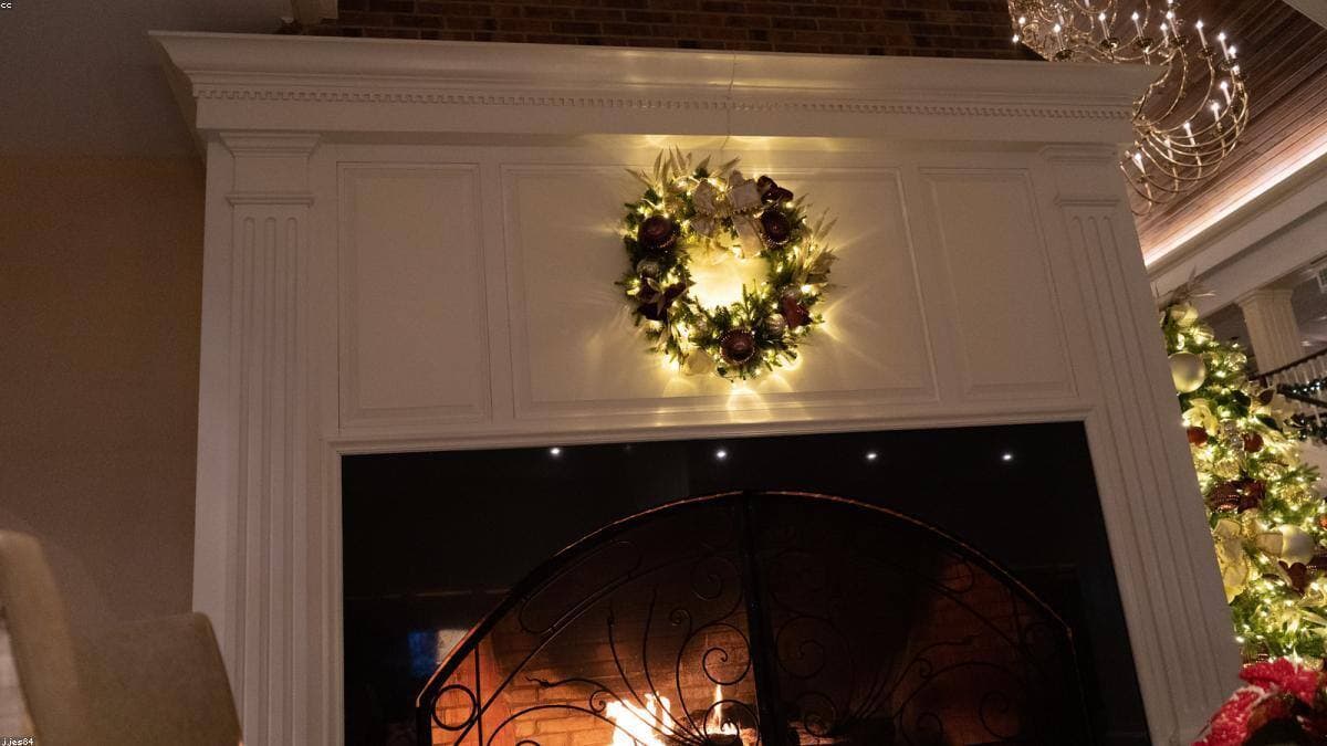 A candle glowing warmly in a darkened home.